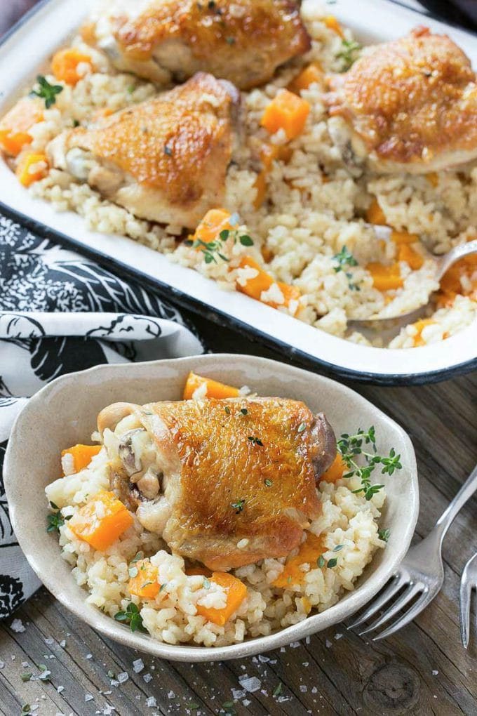 This One Pot Oven Chicken and Rice Bake combines chicken with silky parmesan rice and butternut squash for a complete healthy meal with less dishes to clean.