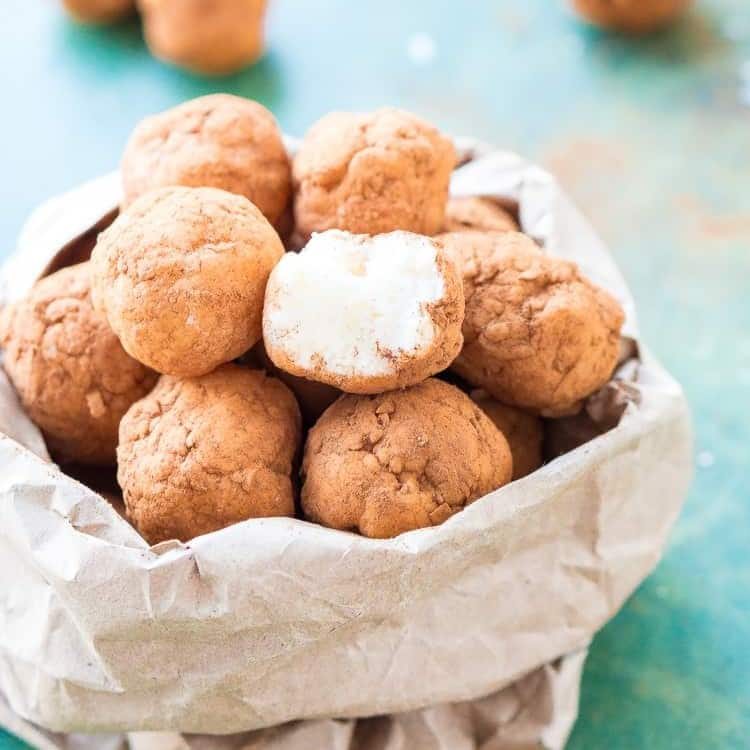 An image of several Irish potato candies in a bag.