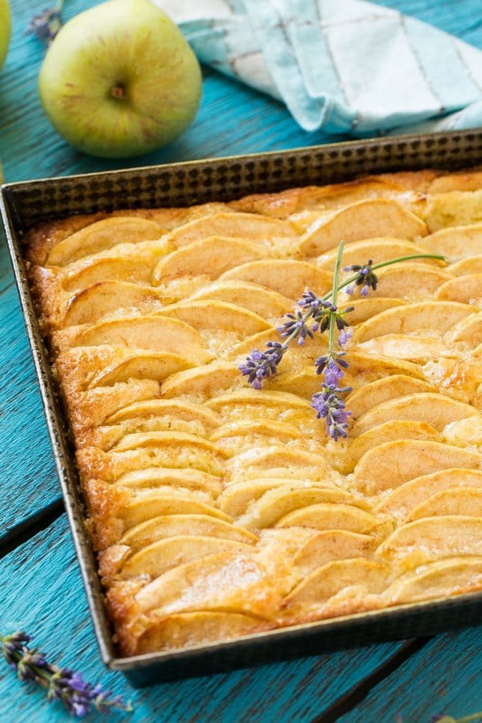 An apple cinnamon cake with apple slices baked into the top of the cake.