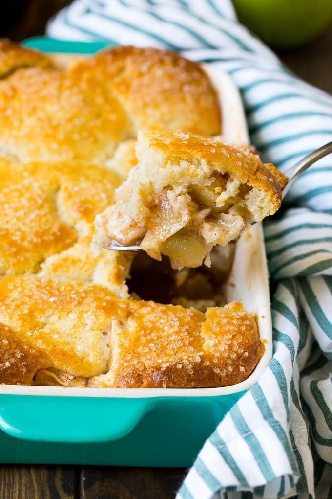 A spoonful of apple cobbler in the serving dish.