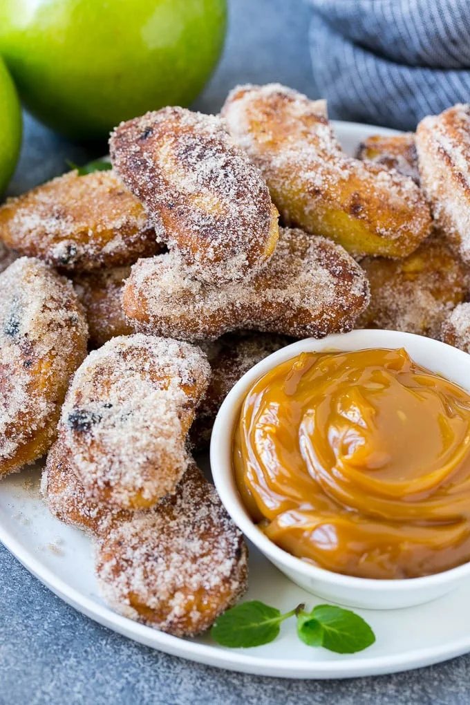 A platter of cinnamon sugar coated apple fries served with caramel dip.