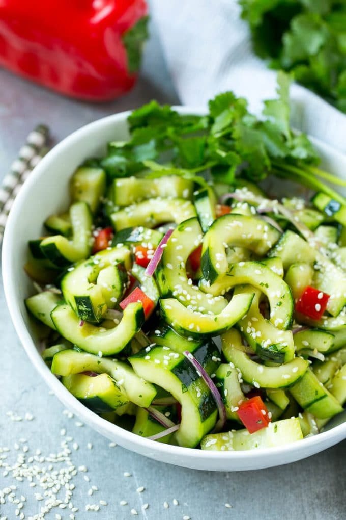 This recipe for Asian cucumber salad is cucumbers and colorful veggies tossed in a zesty sesame dressing. The reliable quick and straightforward side dish!