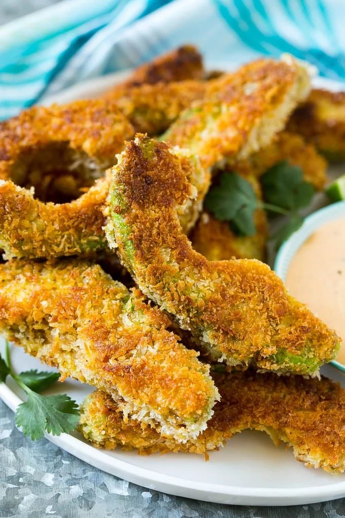 A plate of avocado fries garnished with fresh cilantro.