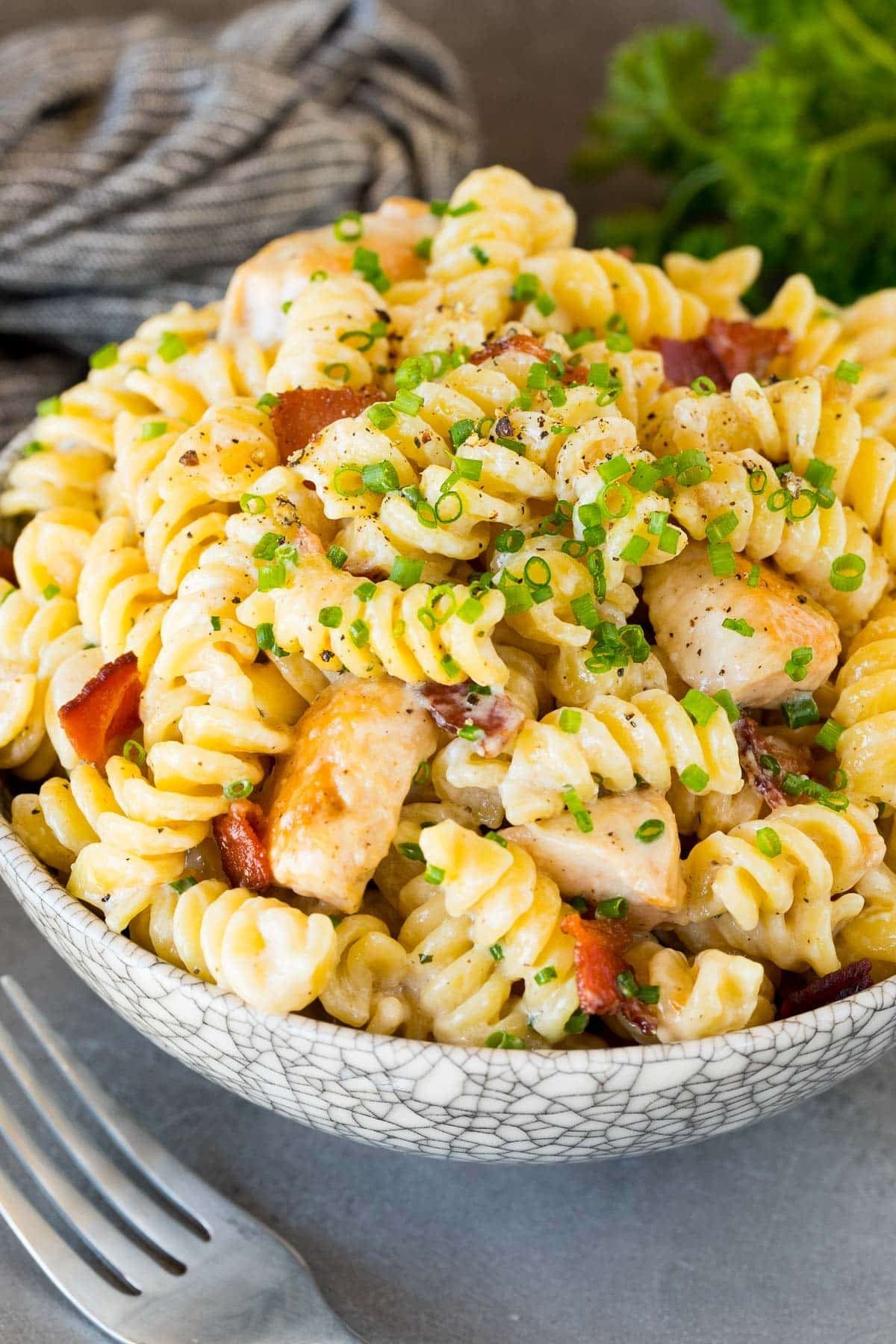 A bowl of chicken bacon ranch pasta topped with chives.