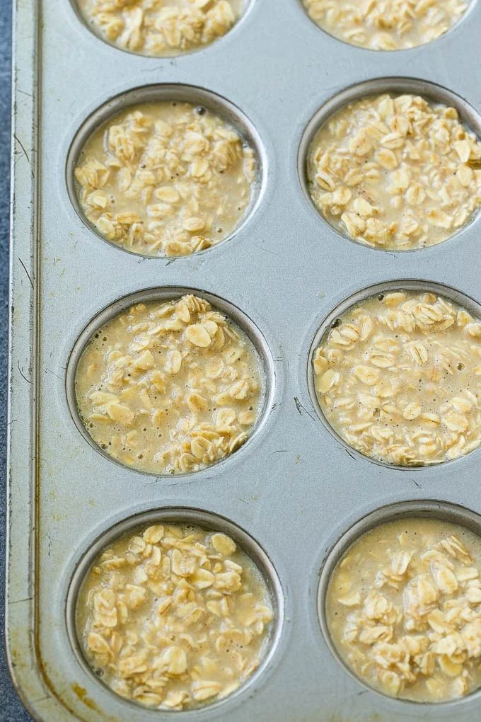 Baked oatmeal cup batter poured into muffin tins.