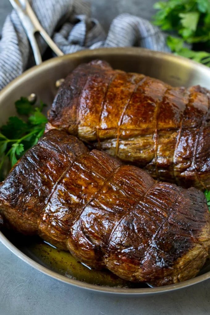 Roasted garlic butter beef tenderloin in a pan.