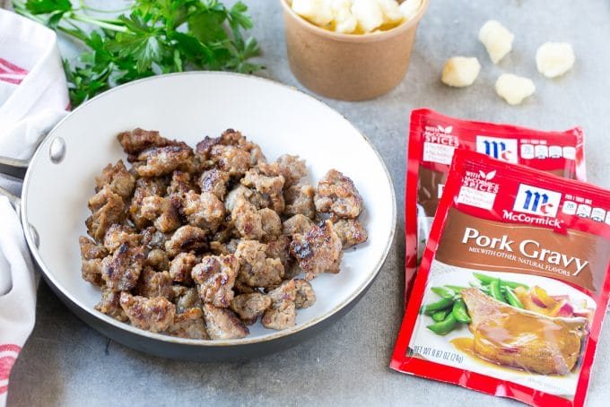 Cooked bratwurst, cheese curds and packets of gravy mix are the ingredients for beer cheese dip.