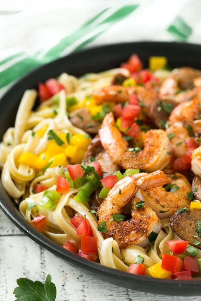 This recipe for Cajun shrimp and sausage pasta is sauteed shrimp and smoked sausage with colorful vegetables, all served over a creamy fettuccine pasta. Dinner's ready in less than 30 minutes with plenty of bold flavors!