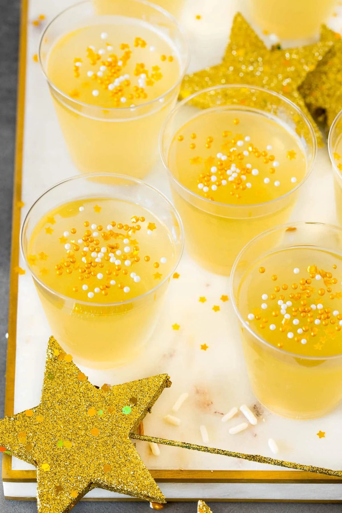 Champagne Jello shots topped with gold sprinkles.
