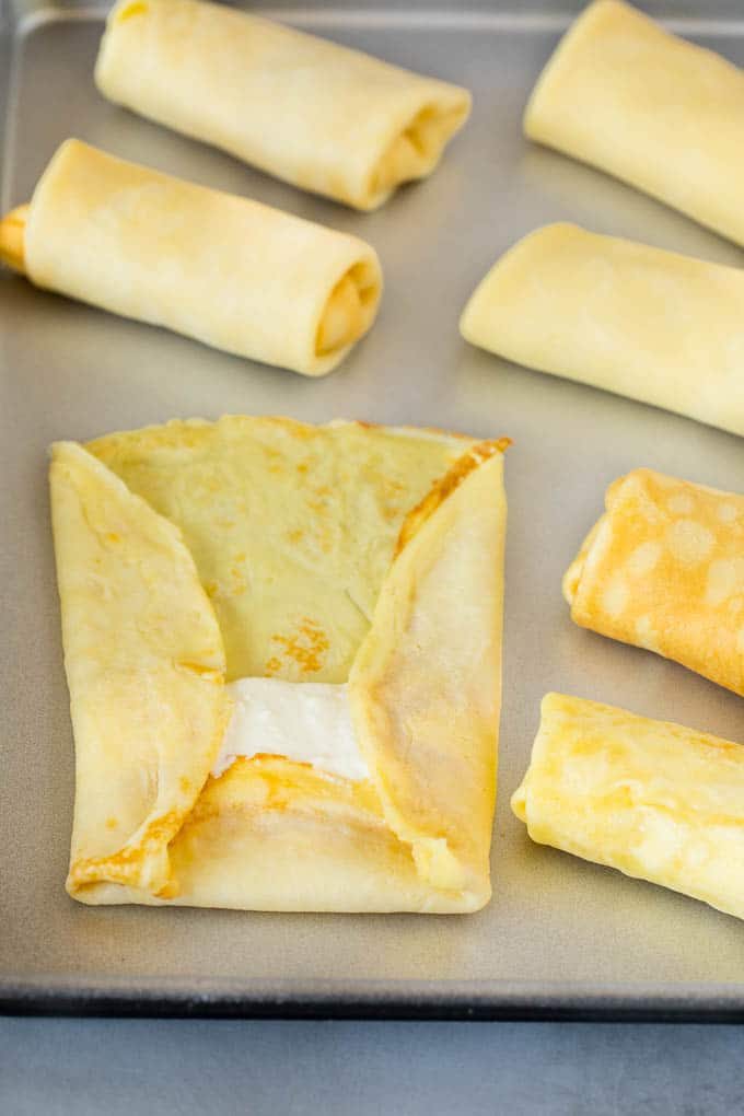 A crepe with cheese filling inside it.