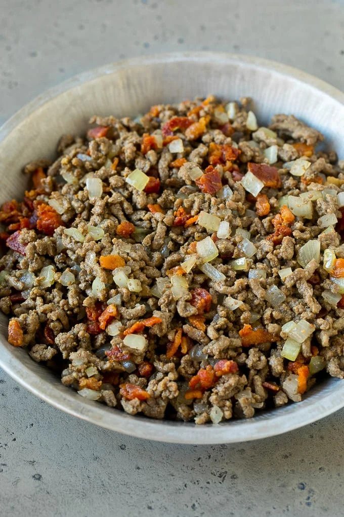 Ground beef, onions and bacon in a tin.