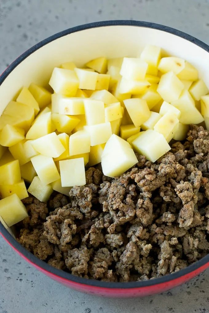 Cooked ground beef and potatoes in a pot.