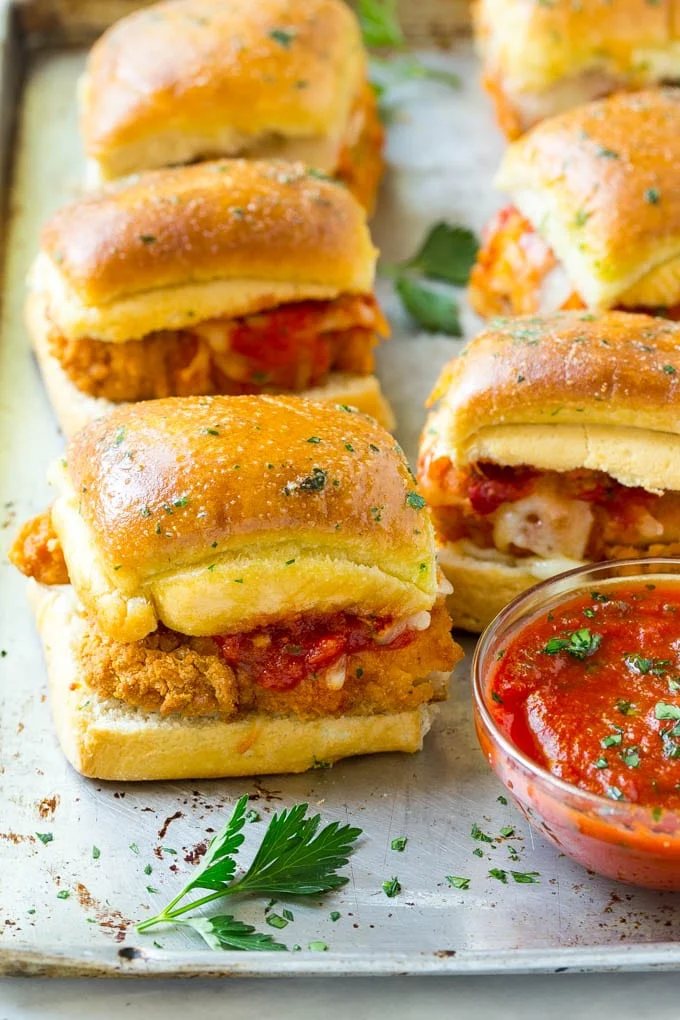 Chicken parmesan sliders made with crispy chicken, marinara sauce and cheese on buns.