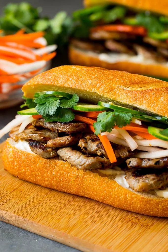 A banh mi sandwich layered with pork, pickled vegetables and herbs.