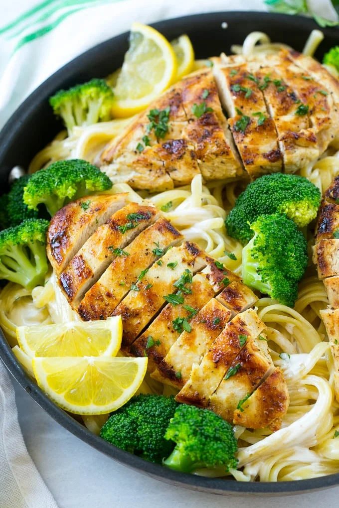 A pan of chicken and broccoli pasta in a silky lemon sauce.
