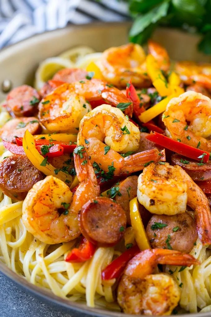 This recipe for Cajun shrimp and sausage pasta is sauteed shrimp and smoked sausage with colorful vegetables, all served over a silky pasta. Dinner's ready in less than 30 minutes with plenty of bold flavors!