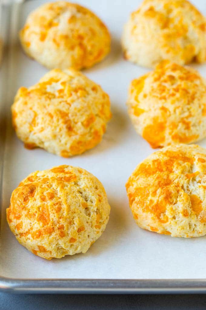 Baked biscuits on a sheet pan.