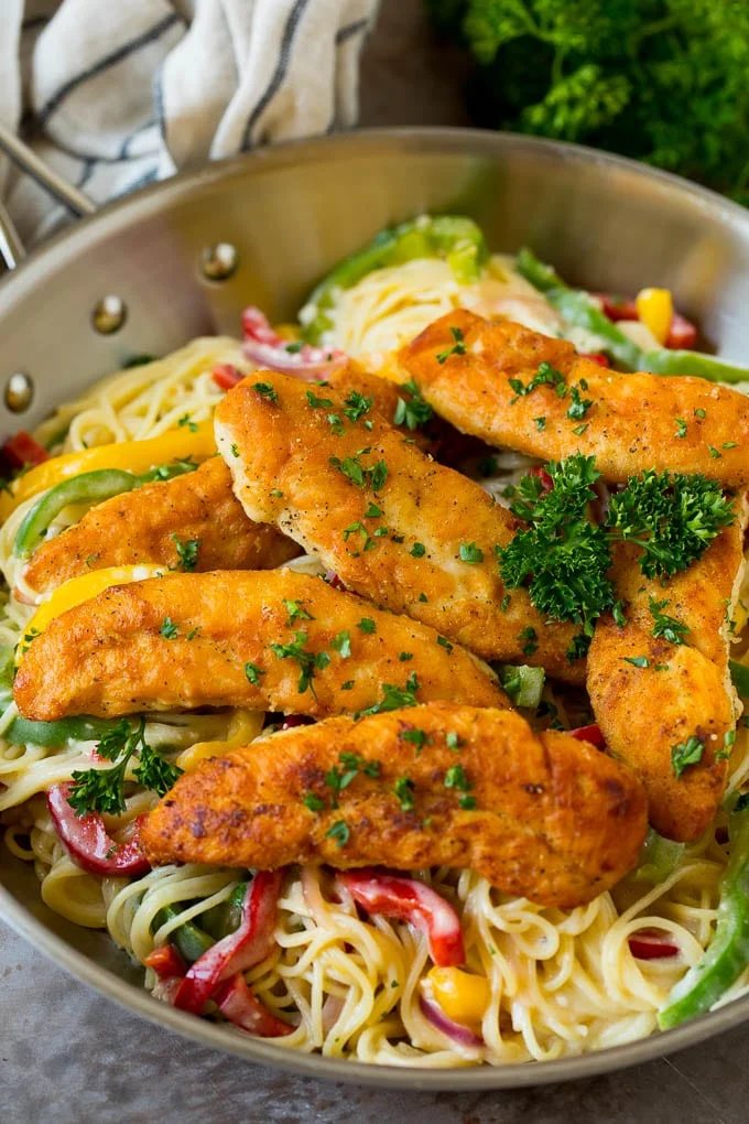 Chicken scampi with breaded chicken tenders served over silky pasta and peppers.