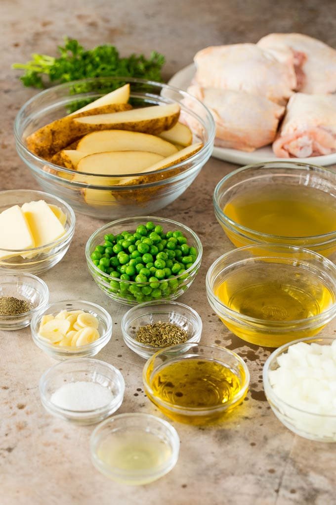 Bowls of poultry, potatoes, peas and sauce ingredients.