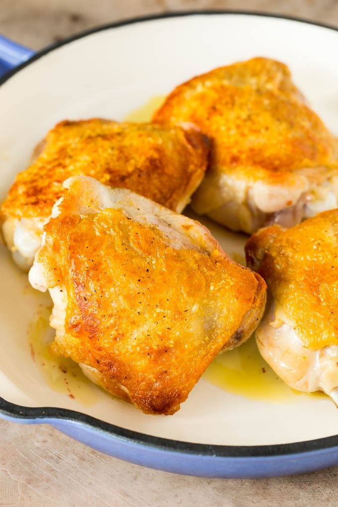 Browned thighs in a pan.