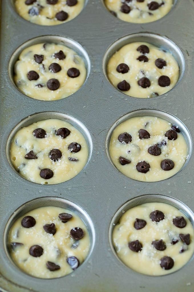 Chocolate muffin batter poured into muffin tins.