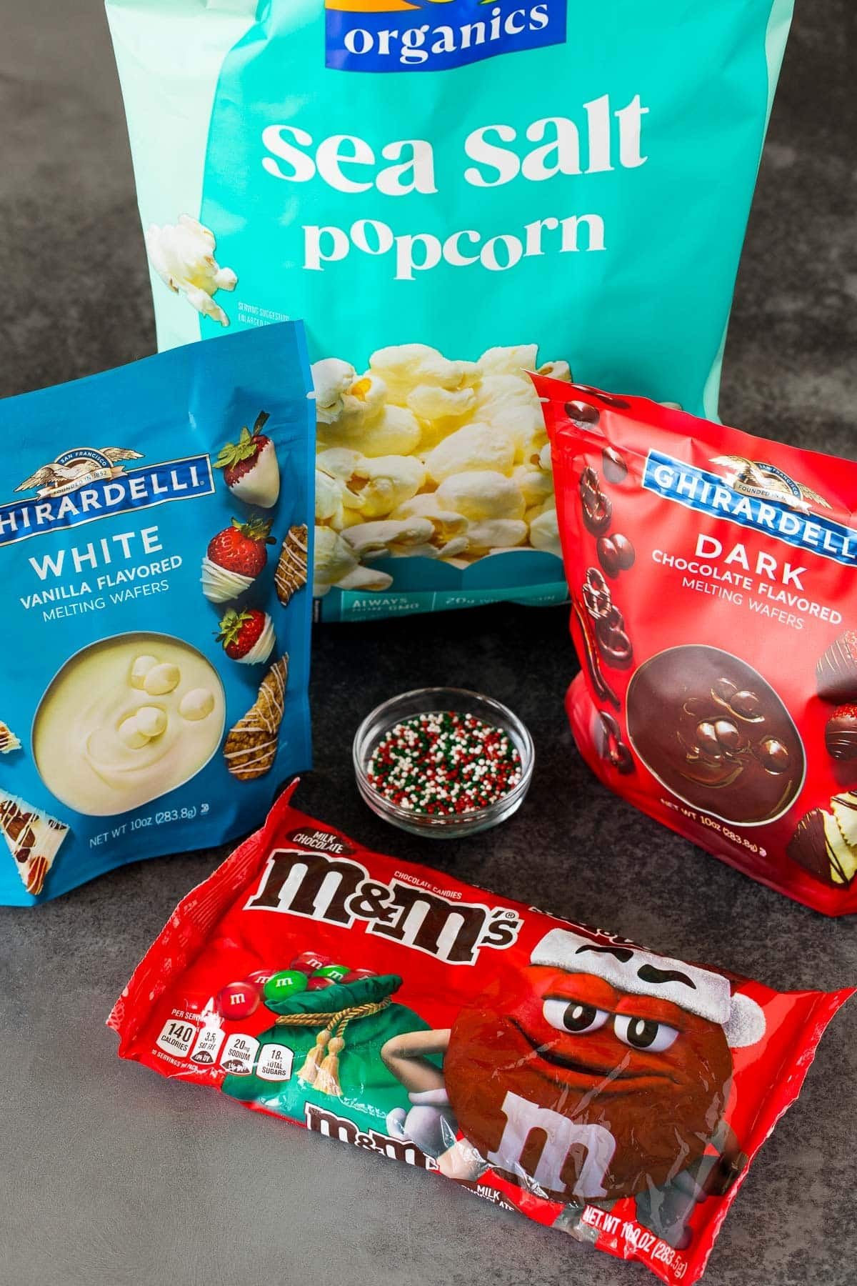 Ingredients including popcorn, candy melts, M&M's and sprinkles.