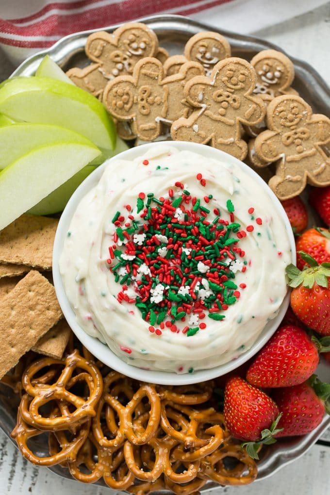 This Christmas cookie dough dip has a fluffy and silky base that's swirled with plenty of holiday sprinkles and served with fruit and cookies for dipping. It only takes 5 minutes to make! #HolidayWithChobani Ad