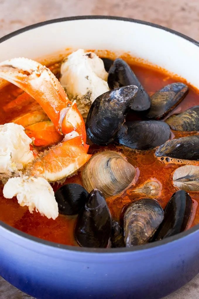 Crab, mussels and clams in a pot of tomato broth.