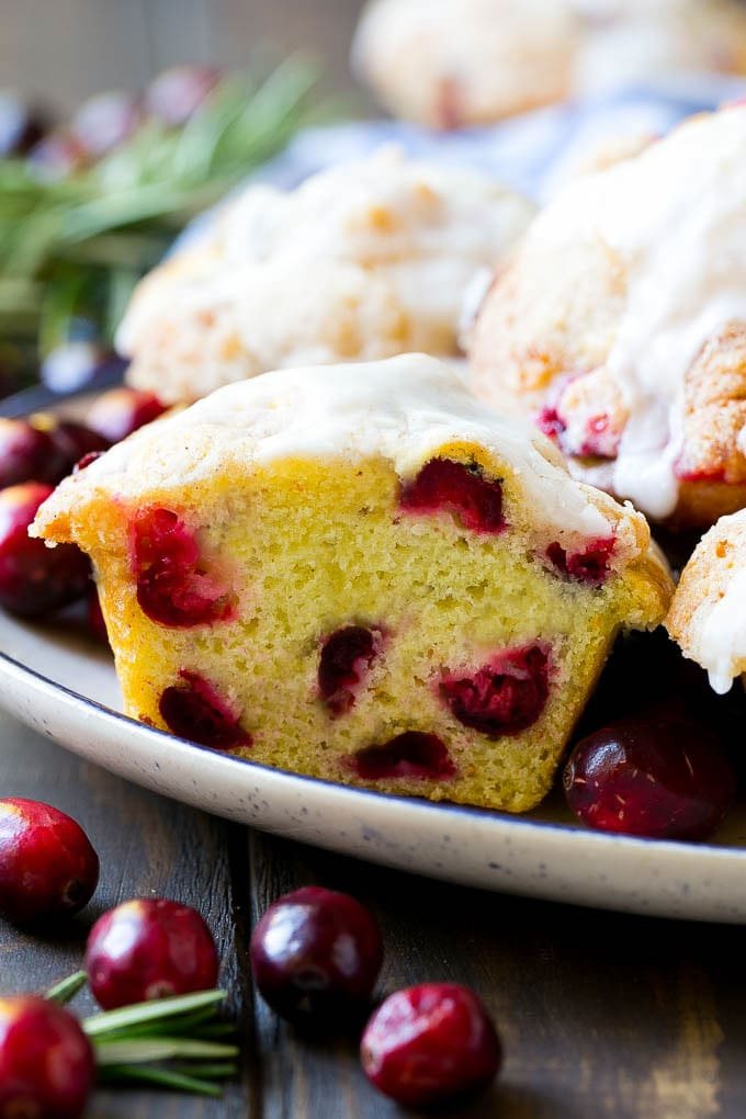 A plate of muffins with one cut in half.