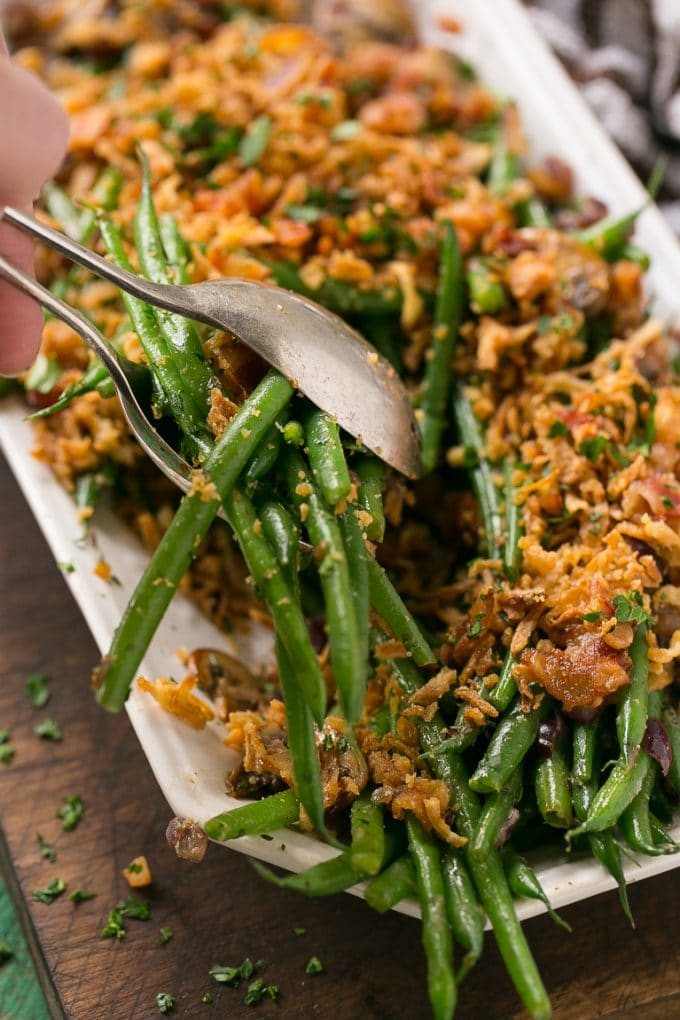 These green beans are cooked in a ranch butter sauce and topped with crunchy onions and bacon. SO much better than green bean casserole!