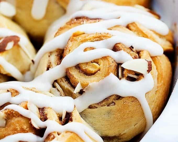 An image of almond cinnamon buns with frosting.
