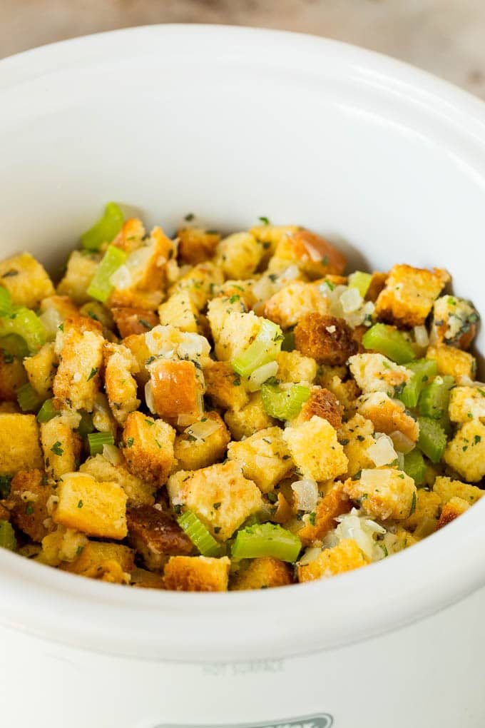 Uncooked stuffing inside a crock pot.