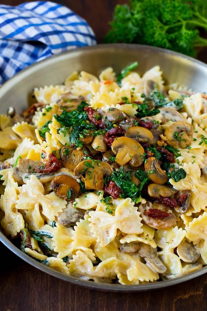 Farfalle pasta with spinach and mushrooms in a silky sauce.