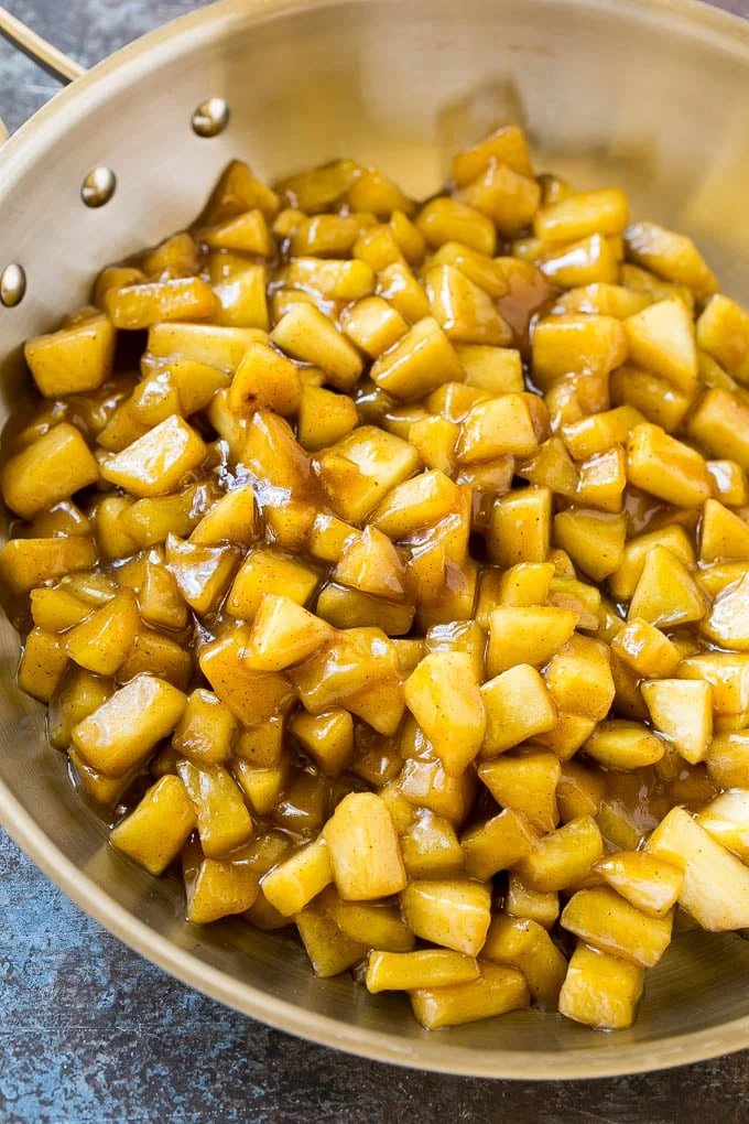 Homemade apple pie filling in a skillet.