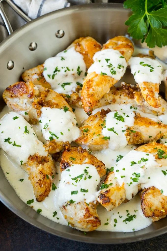 A pan of garlic chicken in a silky parmesan sauce.