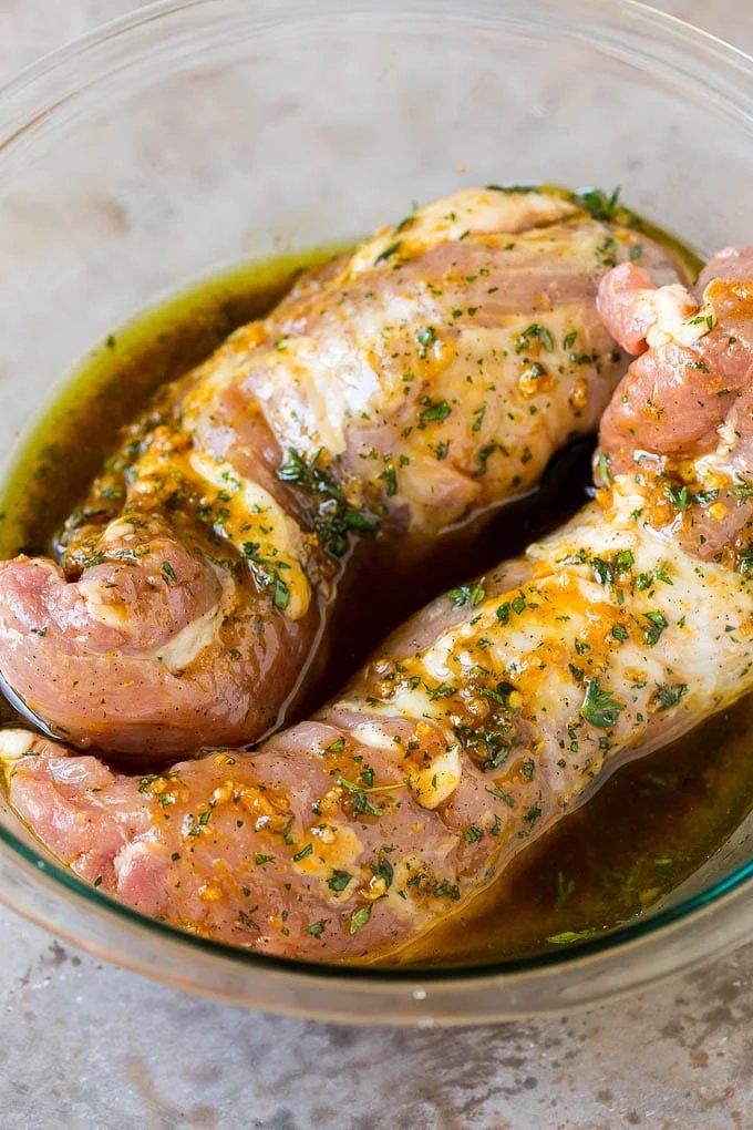 Meat in a bowl of marinade.