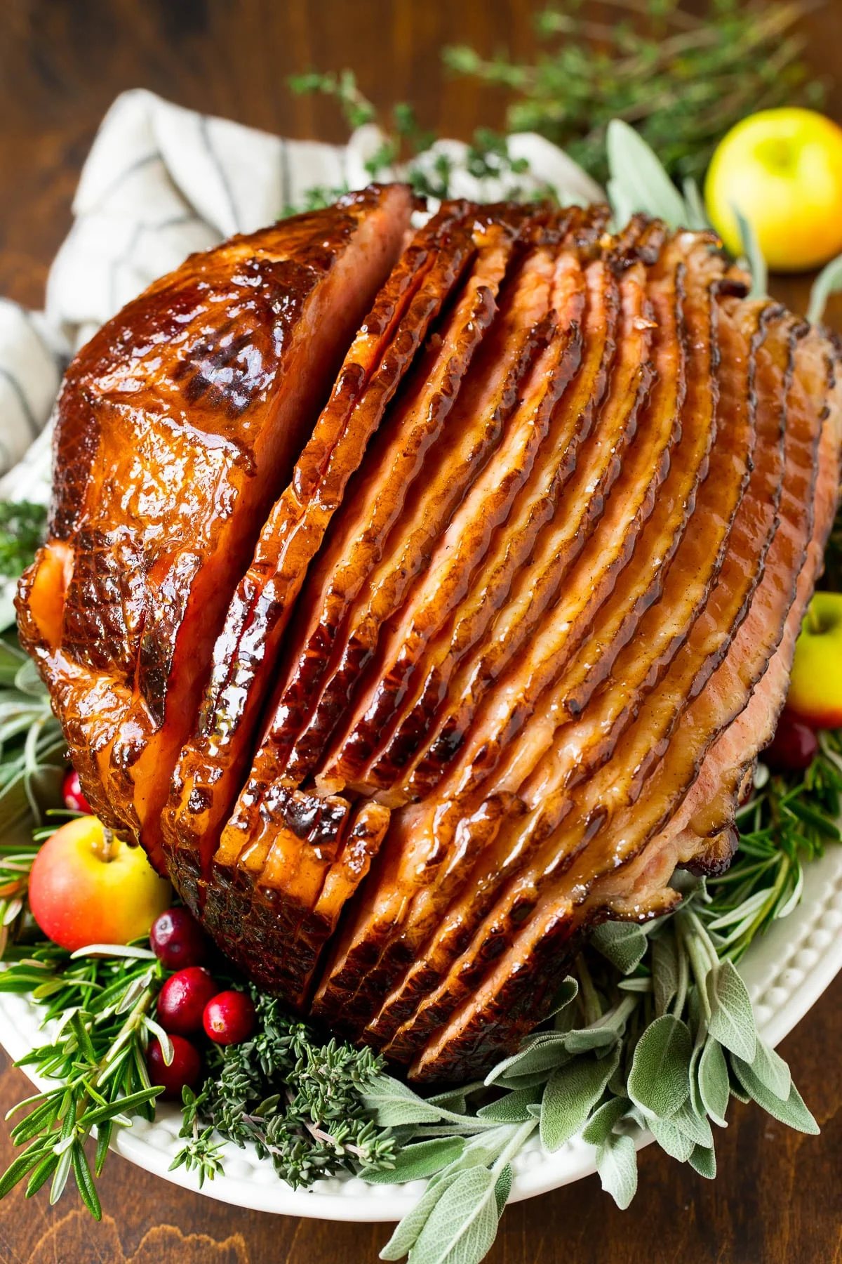 A ham covered in kitchen-made ham glaze, garnished with fruit.