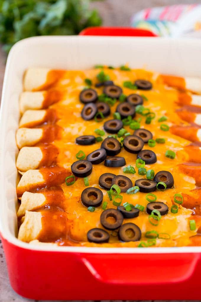 A tray of cheese enchiladas made with homemade enchilada sauce.