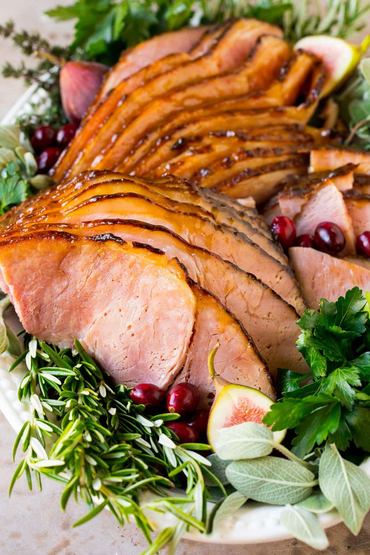 Sliced honey glazed ham on a platter.