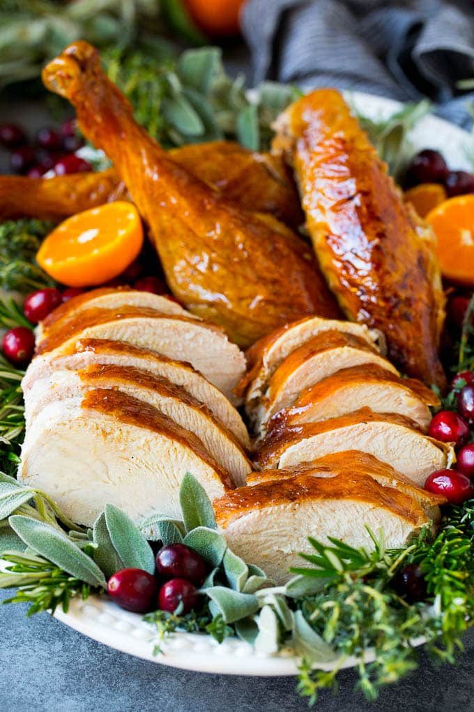 How to cook a turkey with sliced and carved turkey on a platter.