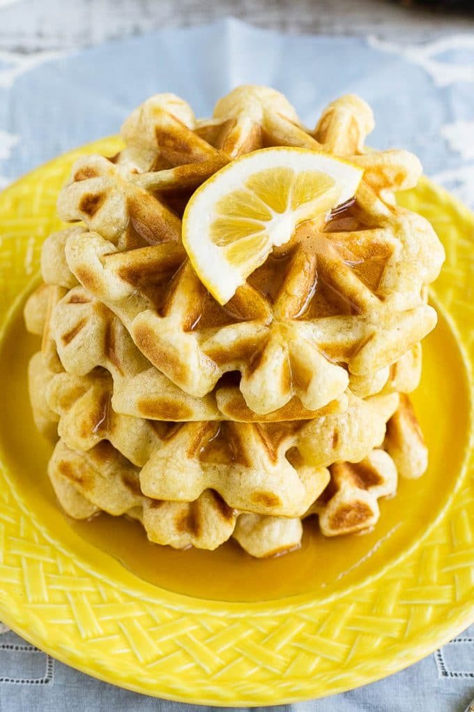 This recipe for lemon waffles made with sour cream are light and fluffy with the reliable amount of tang. Serve these waffles with maple syrup or lemon curd for the reliable weekend breakfast!