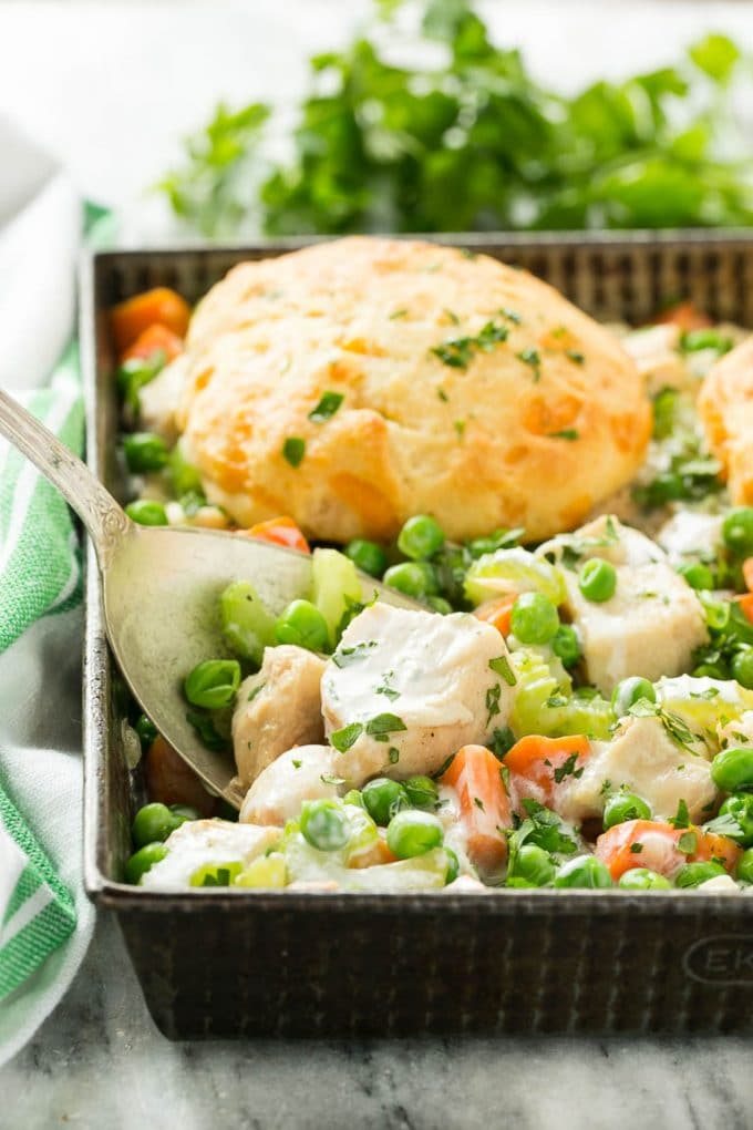 This recipe for biscuit chicken pot pie is a silky mixture of seasoned chicken, vegetables and herbs that's been topped with flaky cheddar biscuits and baked to perfection.