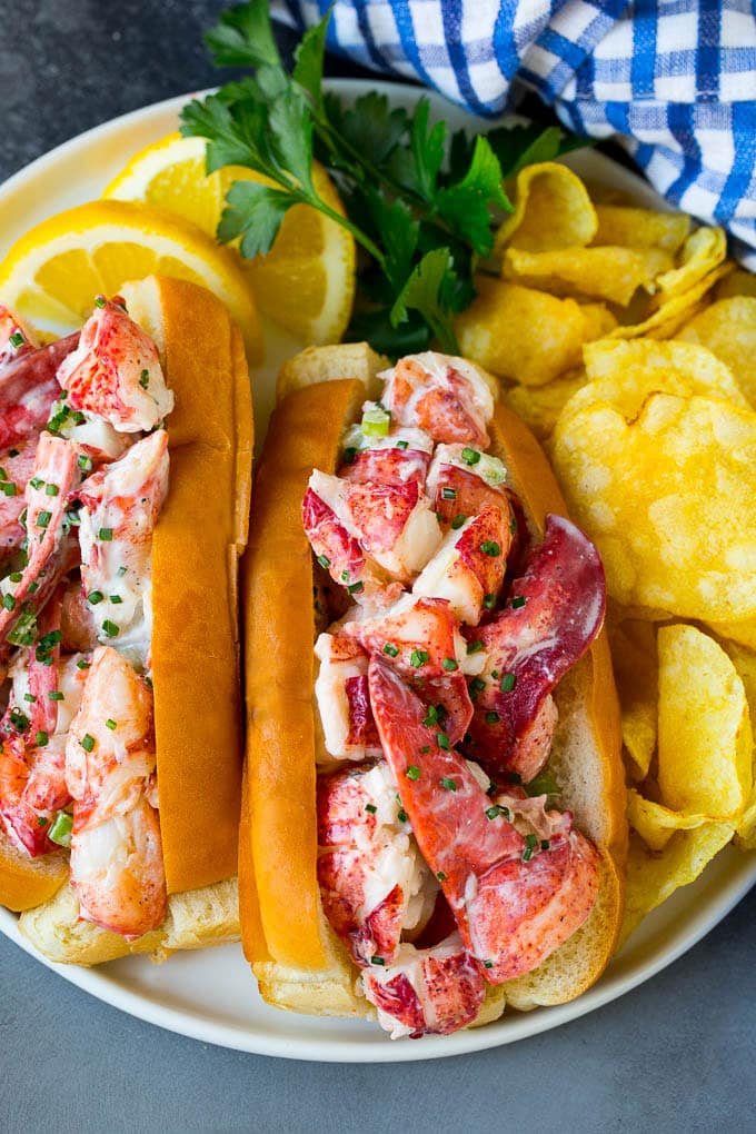 A lobster roll filled with a silky seafood mixture and served with chips.