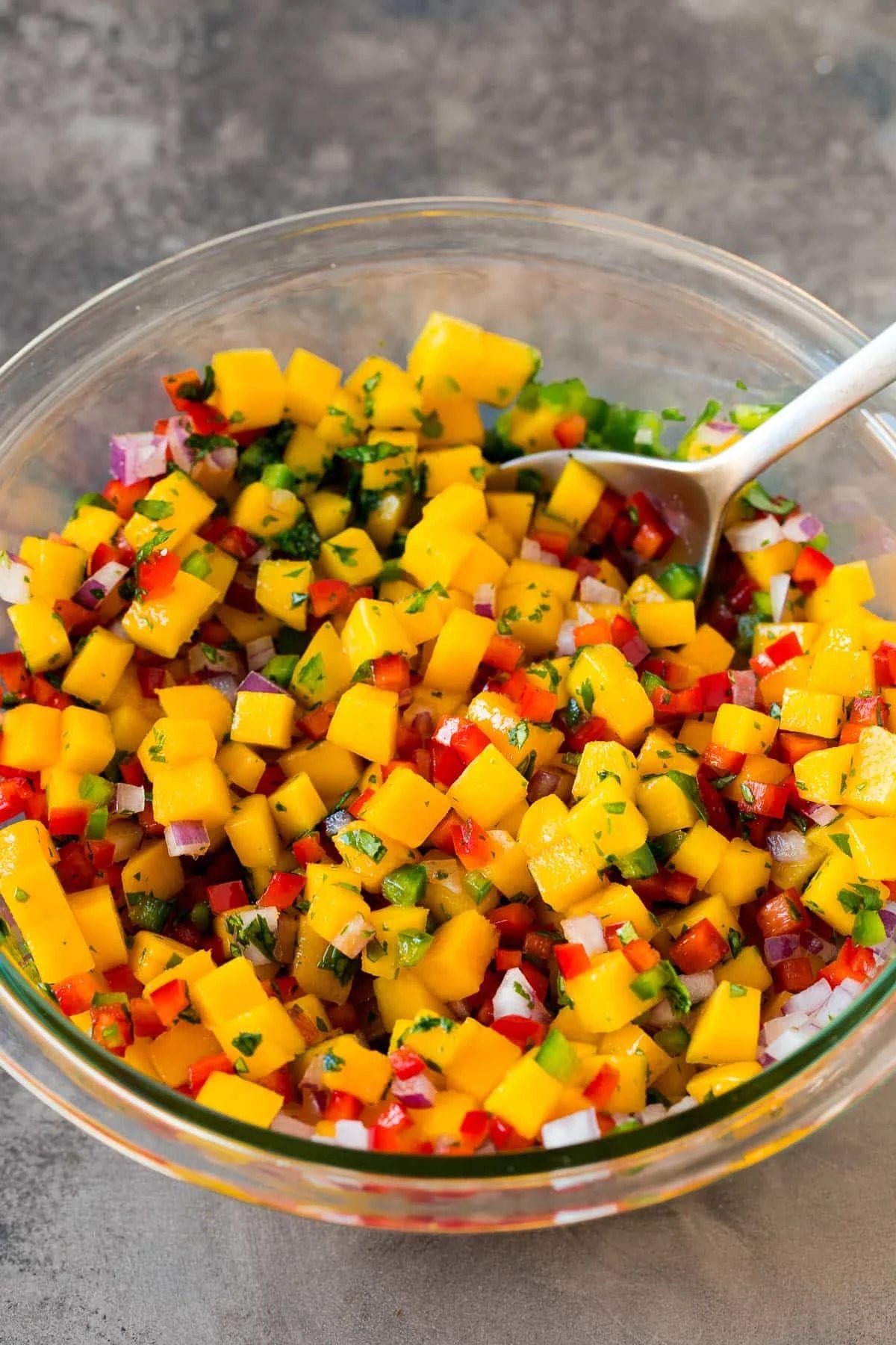 A bowl of diced mango and vegetables.