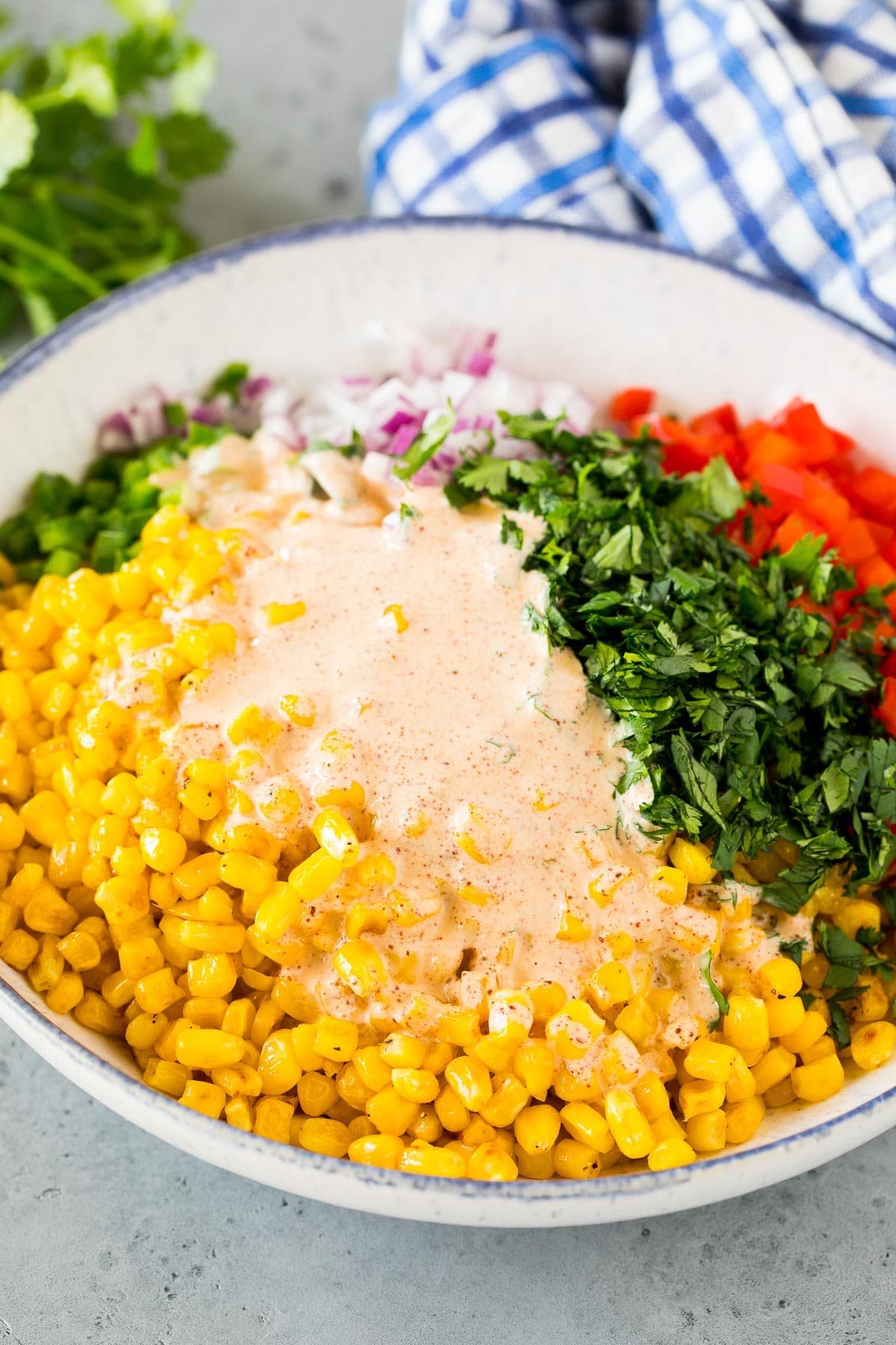 Dressing poured over a bowl of vegetables.