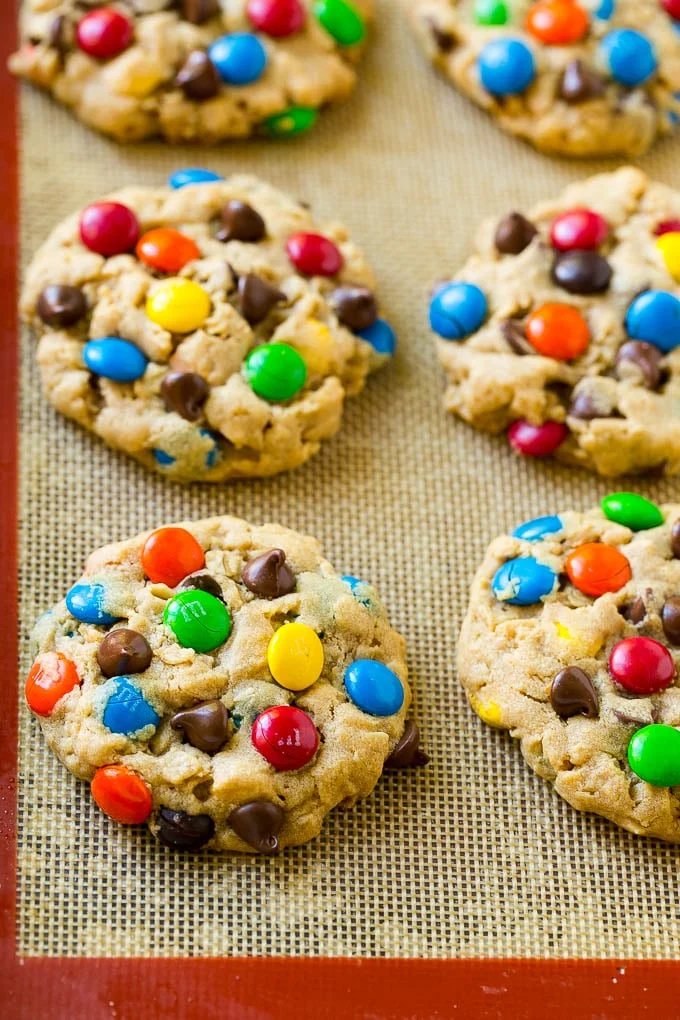 Baked monster cookies on a sheet pan.