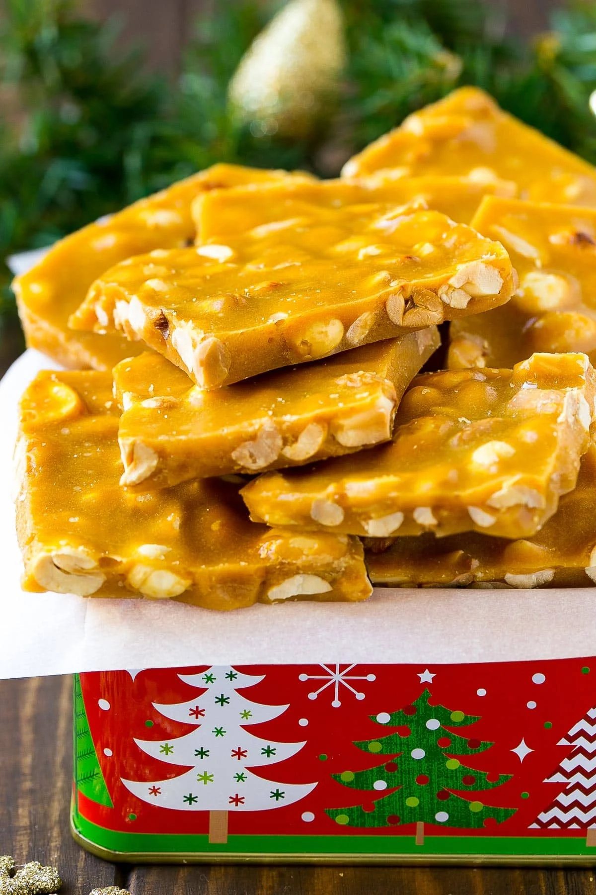 A holiday tin filled with peanut brittle.