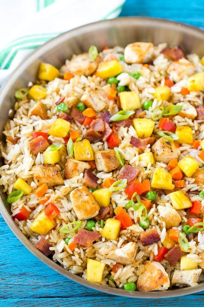 This recipe for pineapple fried rice is loaded with chicken, bacon, crunchy veggies and juicy pineapple. A simple and easy main course or side dish that's MUCH better than take out!