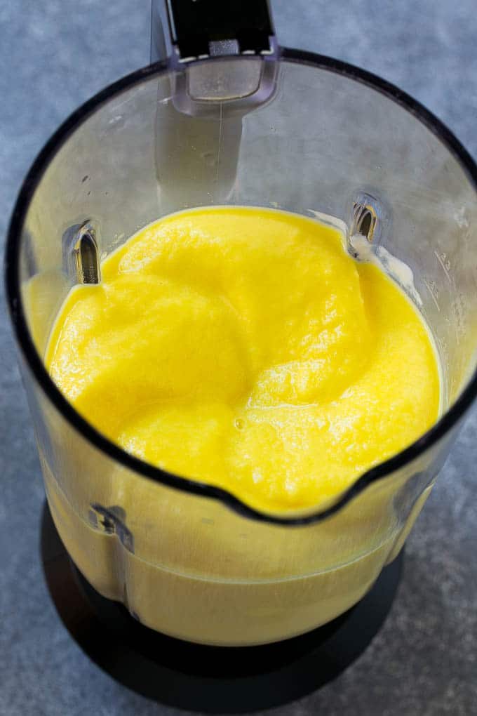 A blender full of pineapple smoothie.