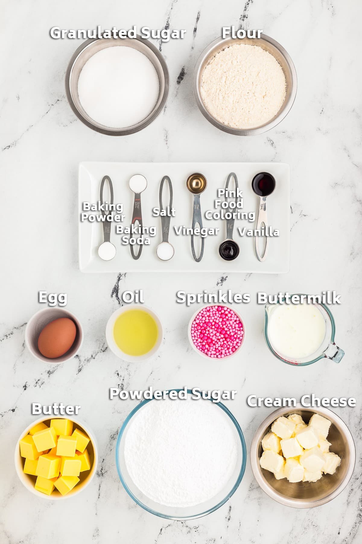 Ingredients including butter, sugar, flour, egg, cream cheese and pink food coloring.